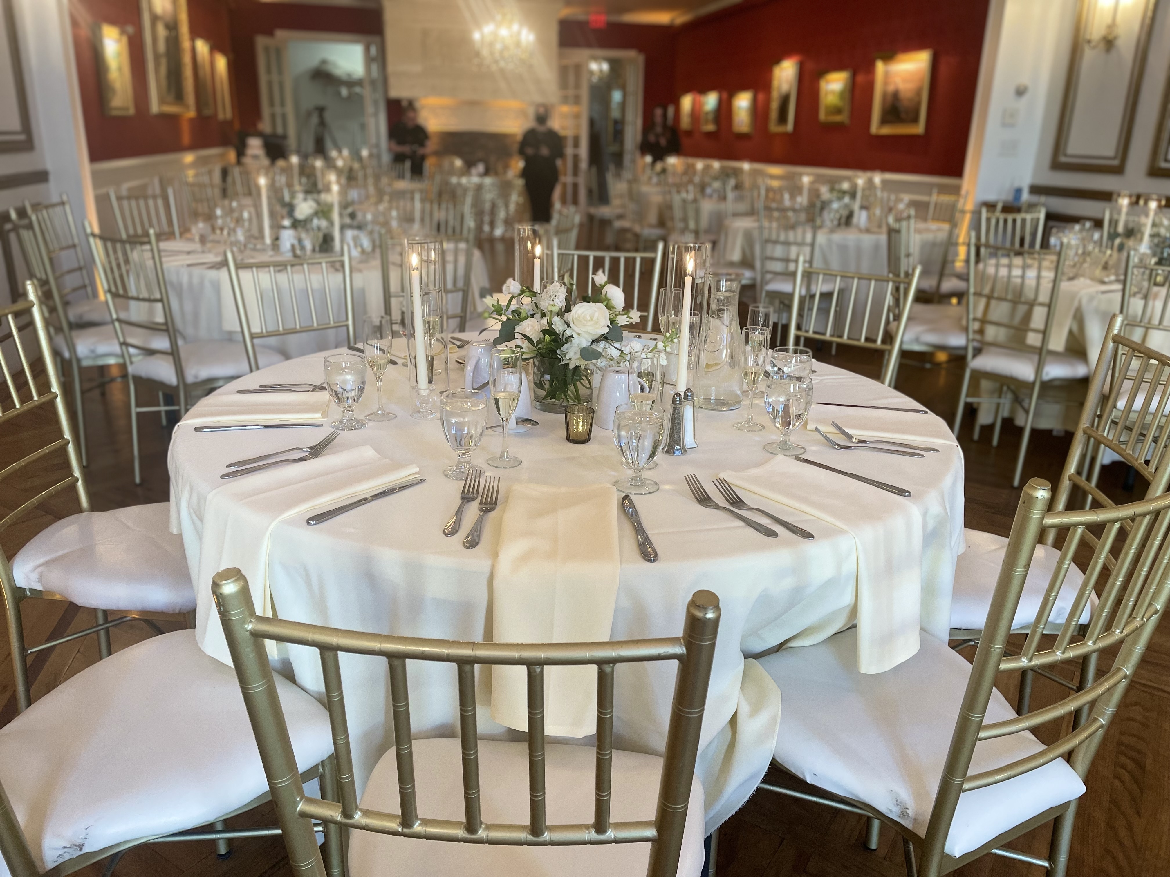 Dining room with gold chairs and florals