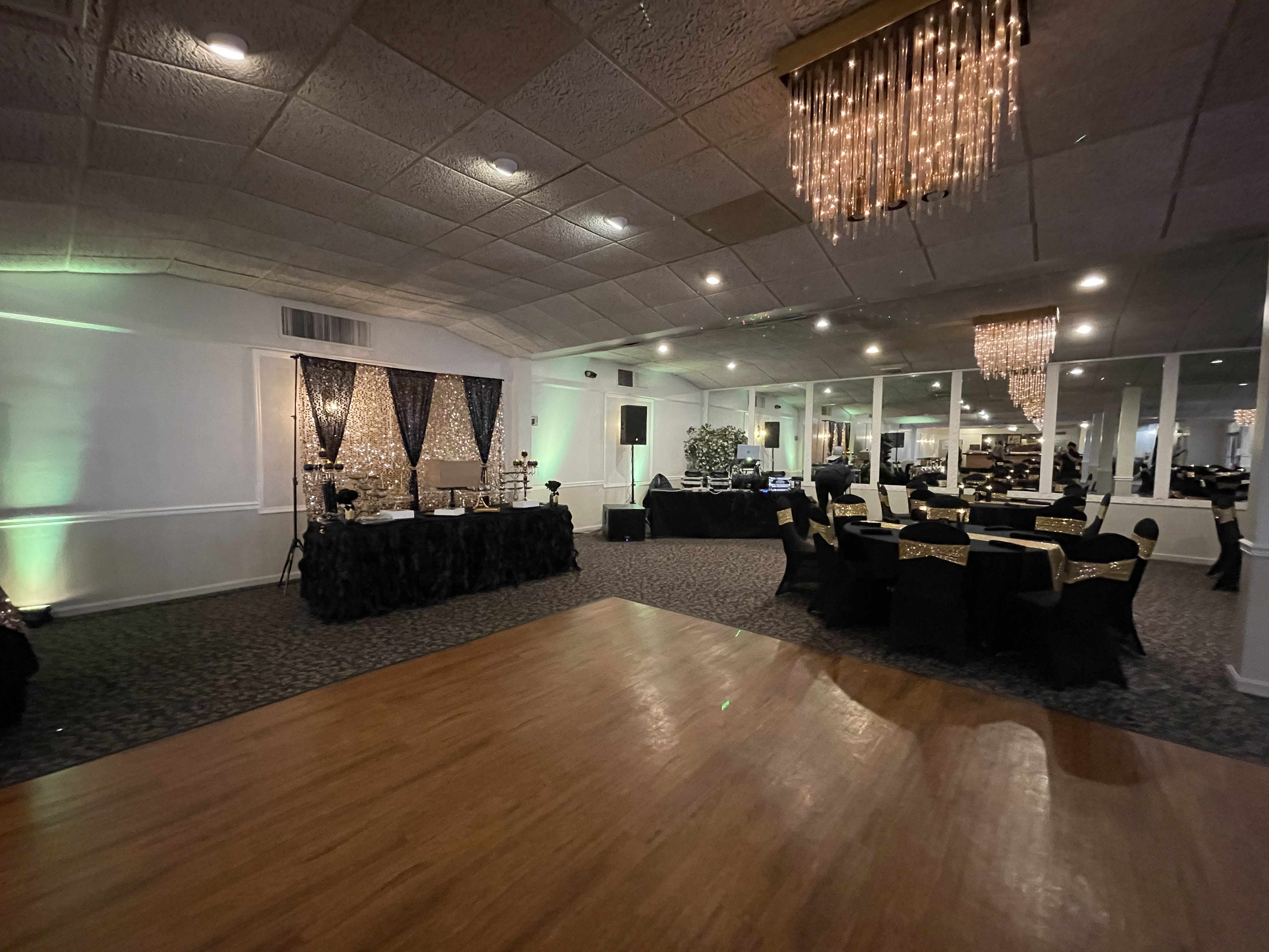 Dance floor with black and gold tables