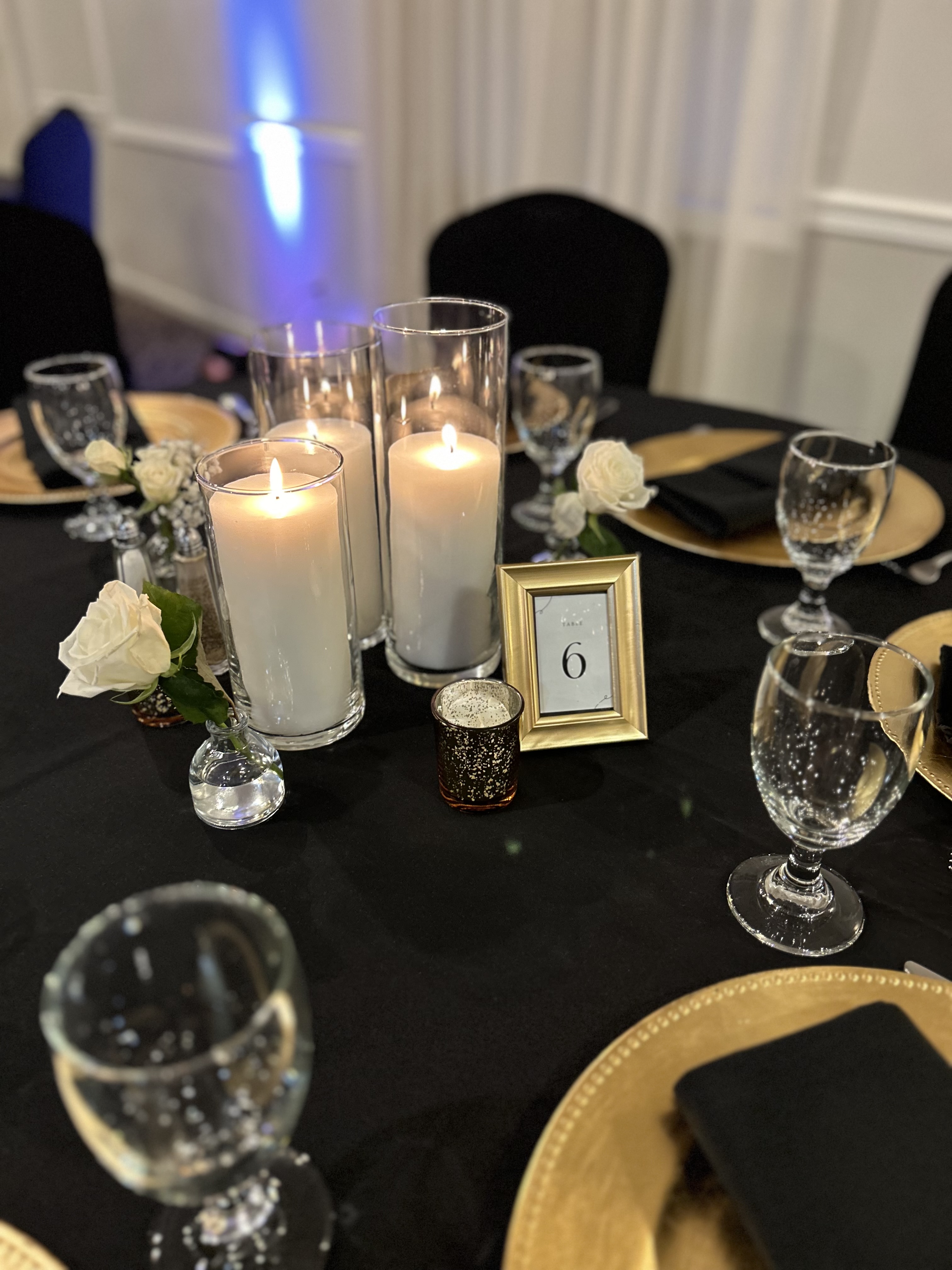 Table number six with candles and roses